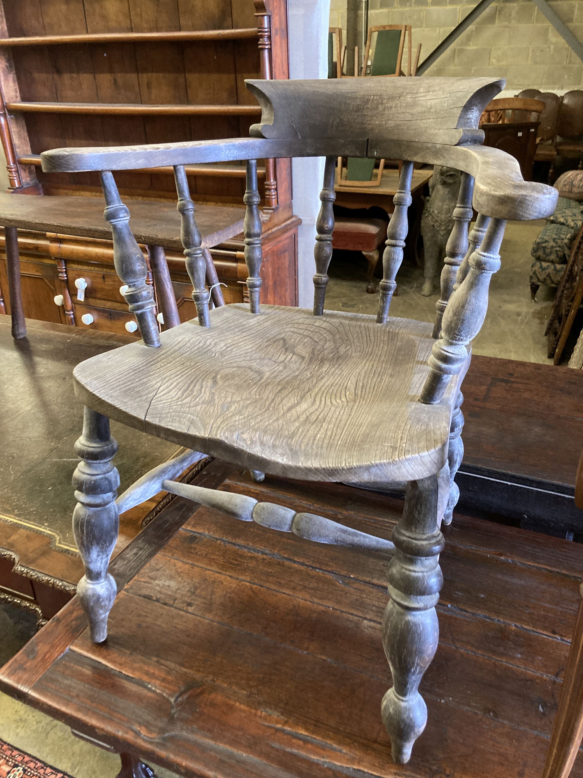 A Victorian bleached elm and ash smokers bow chair and an Edwardian inlaid mahogany elbow chair (2)